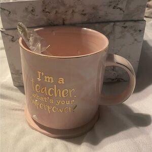 Coffee /tea cup with a coaster and spoon